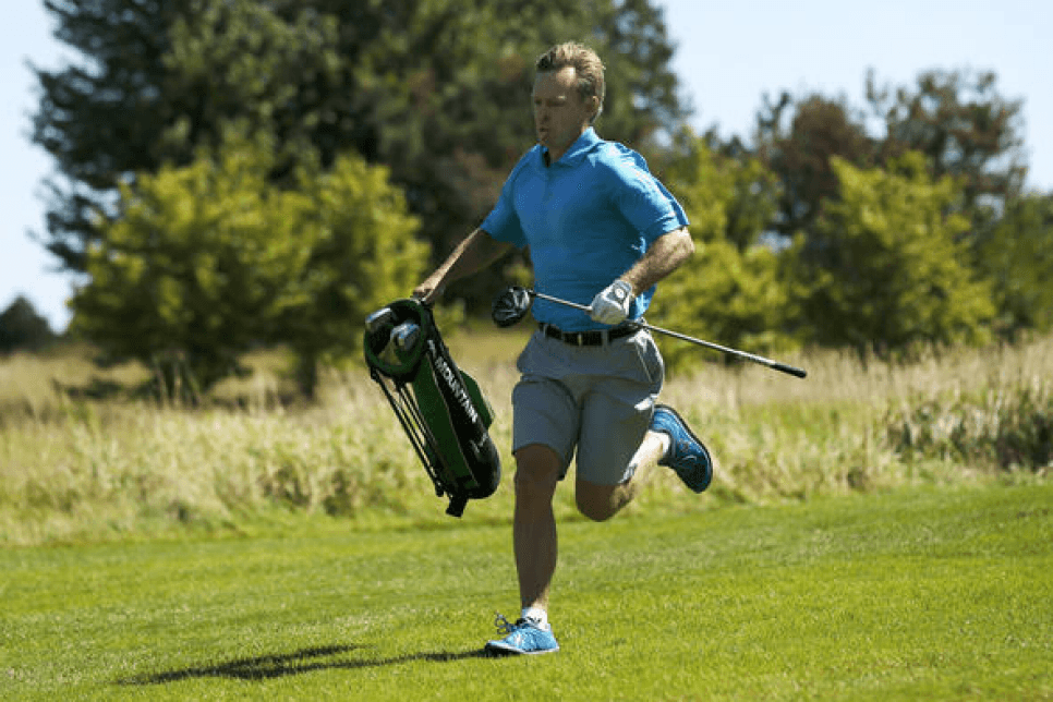 Golfer running down a fairway